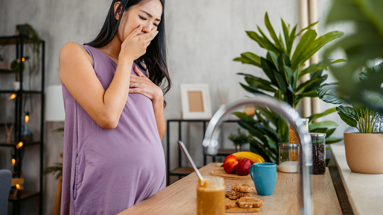 woman hand over mouth and nose