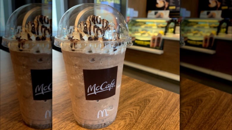 McDonald's Chocolate Frappé sitting on a wooden table