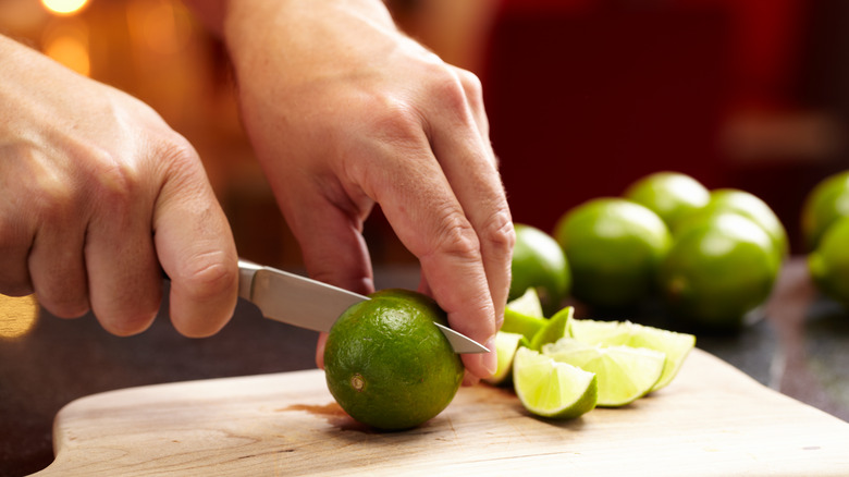 slicing lime with paring knife