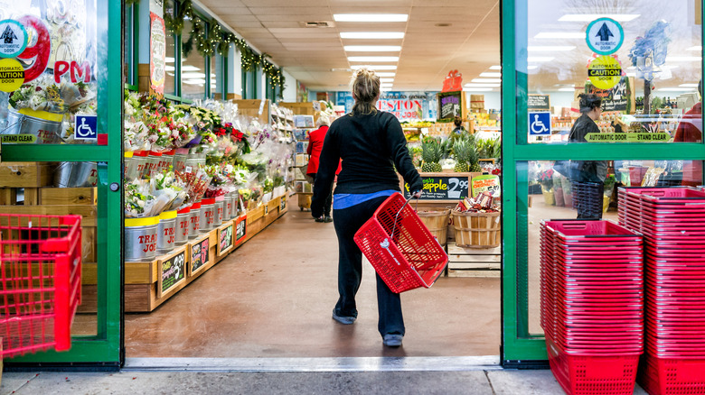 Trader Joe's shopper entering the grocery store with a basket