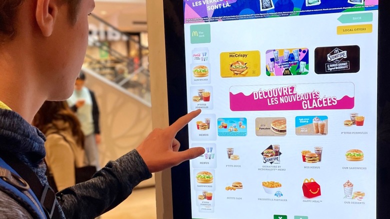 Man ordering from French McDonald's kiosk