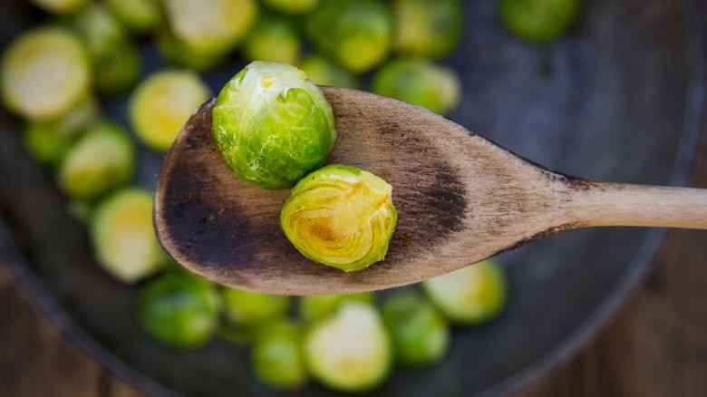 Brussels sprouts on wooden spoon