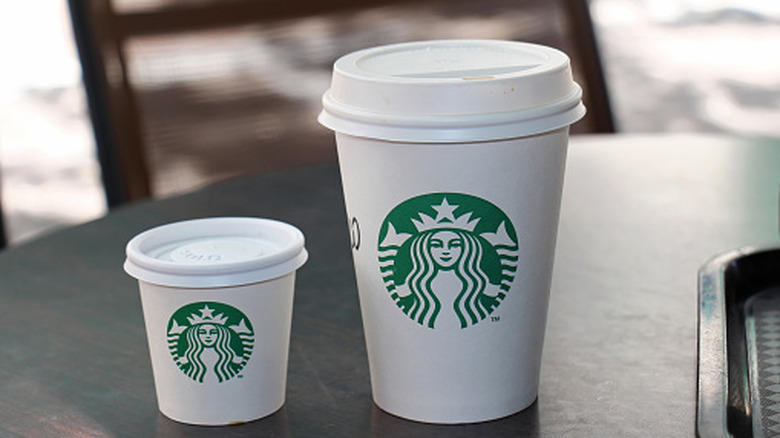 Small Starbucks cup next to a bigger cup