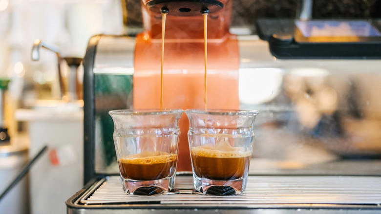 espresso machine pouring shots into two glasses