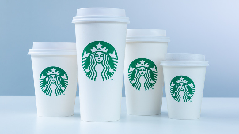 four Starbucks cup of differing sizes
