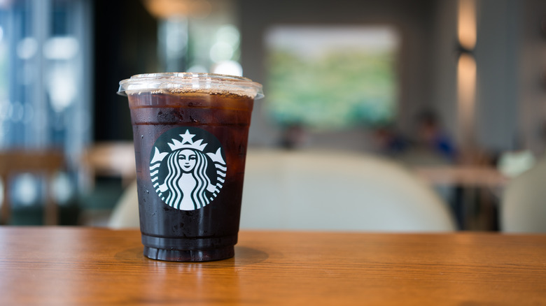 Iced tall Starbucks drink on a table