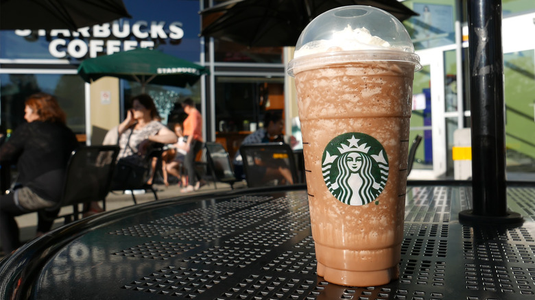 venti coffee cup in front of Starbucks