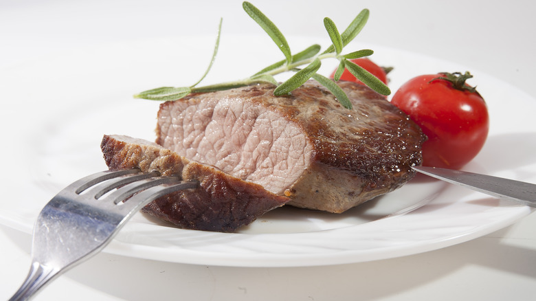 Mediu- well steak with fork