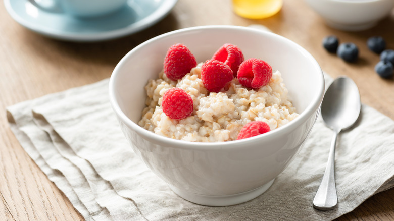 Oatmeal bowl with raspberry toppings