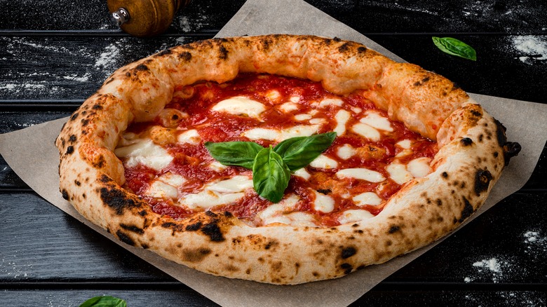 Margherita pizza on dark background