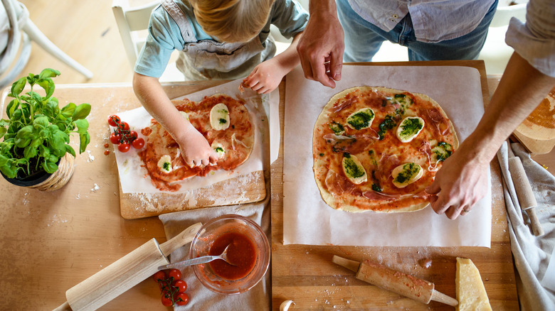 Two people making homemade pizza