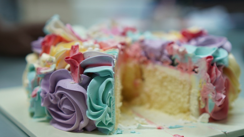 white cake with colorful frosting swirls