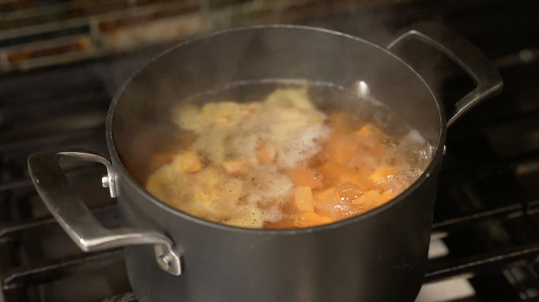 Boiling sweet potatoes on stove. 