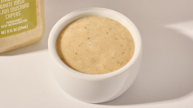 Cup of dressing on a table