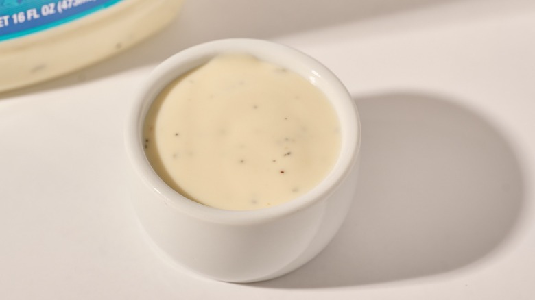 Cup of dressing on a table