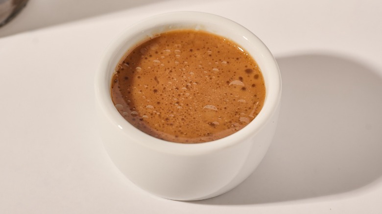 Cup of dressing on a table