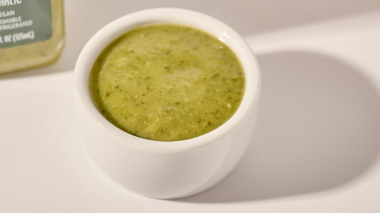 Cup of dressing on a table