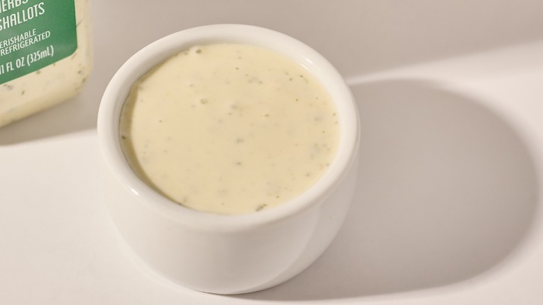 Cup of dressing on a table