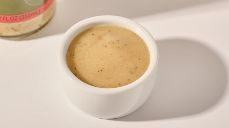 Cup of dressing on a table