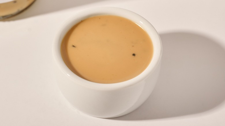 Cup of dressing on a table