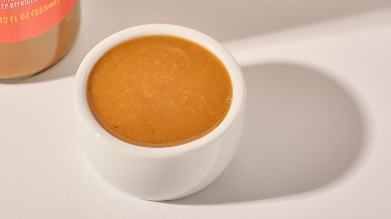 Cup of dressing on a table