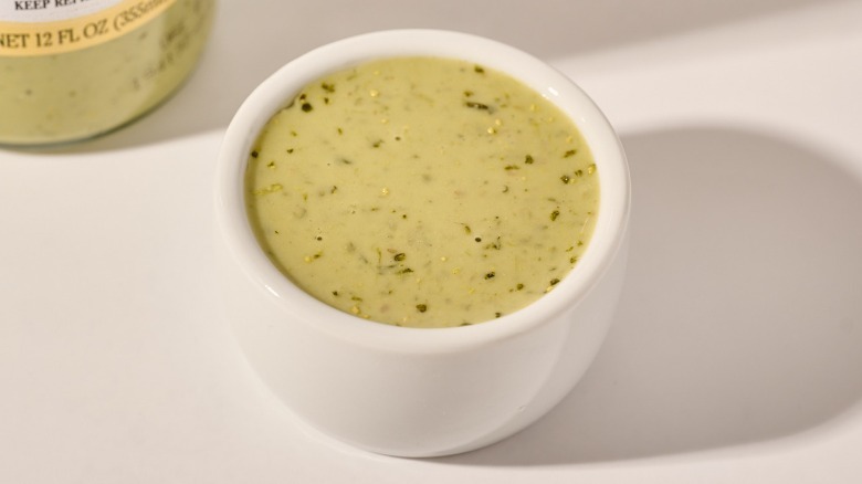 Cup of dressing on a table