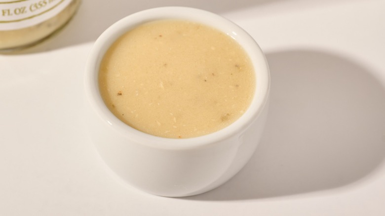 Cup of dressing on a table