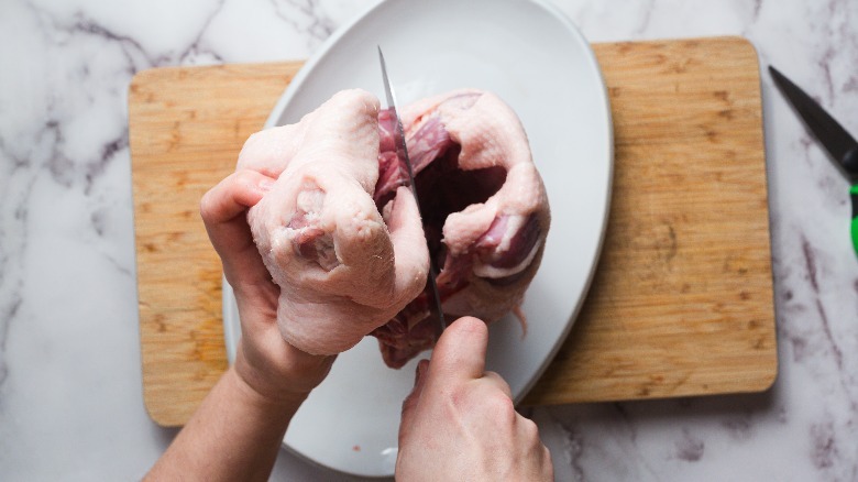 Standing duck upright and cutting in half