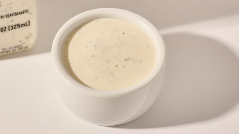Cup of dressing on a table