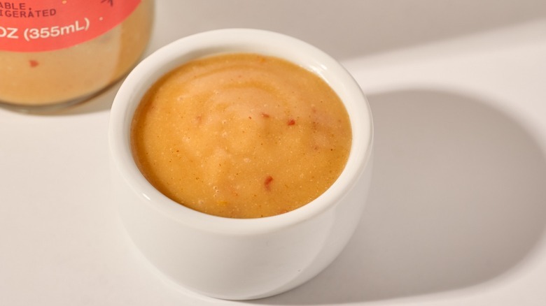 Cup of dressing on a table